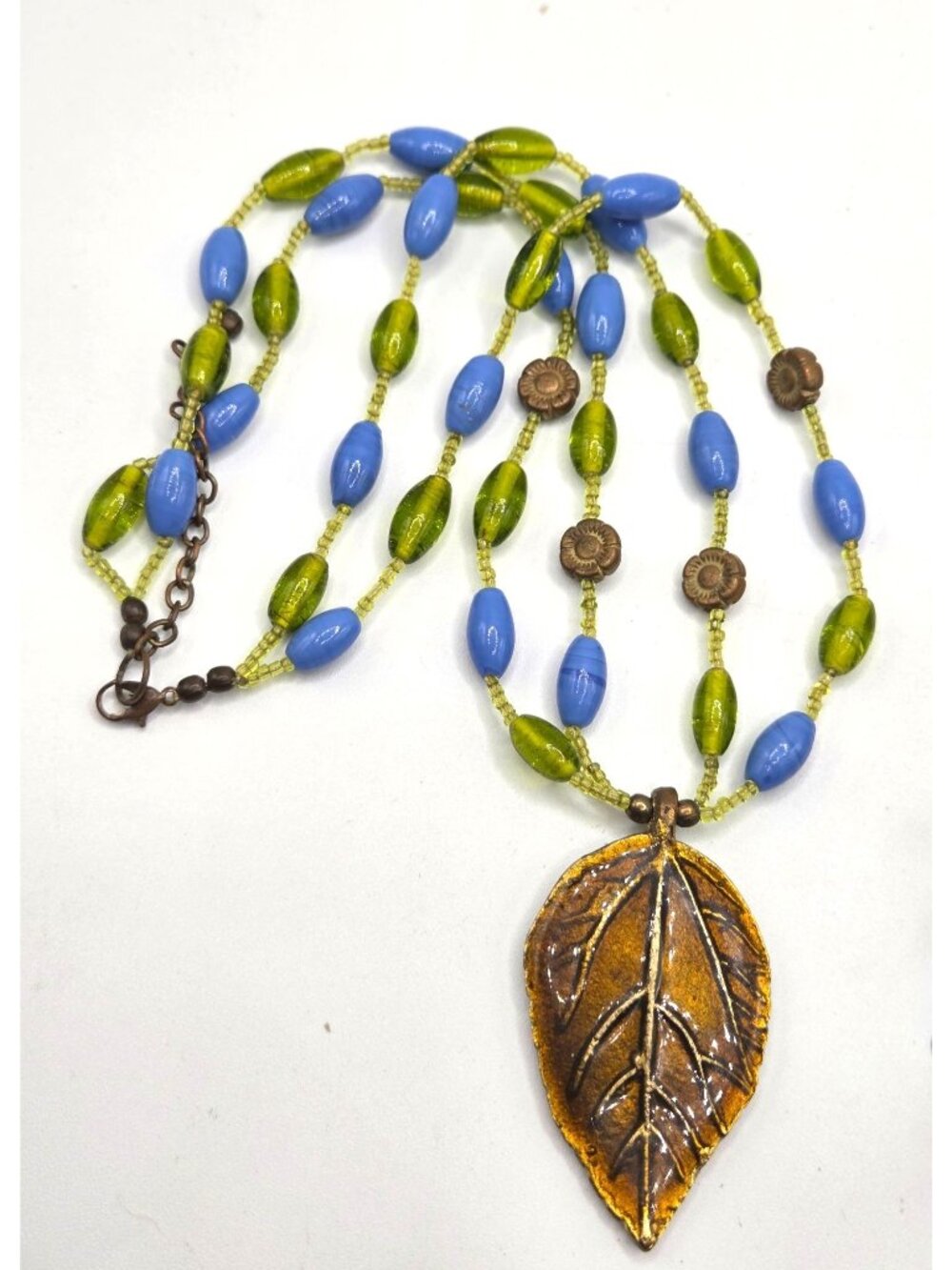 Beaded Necklace With Bronze Leaf Pendant In Blue & Green Glass Beads